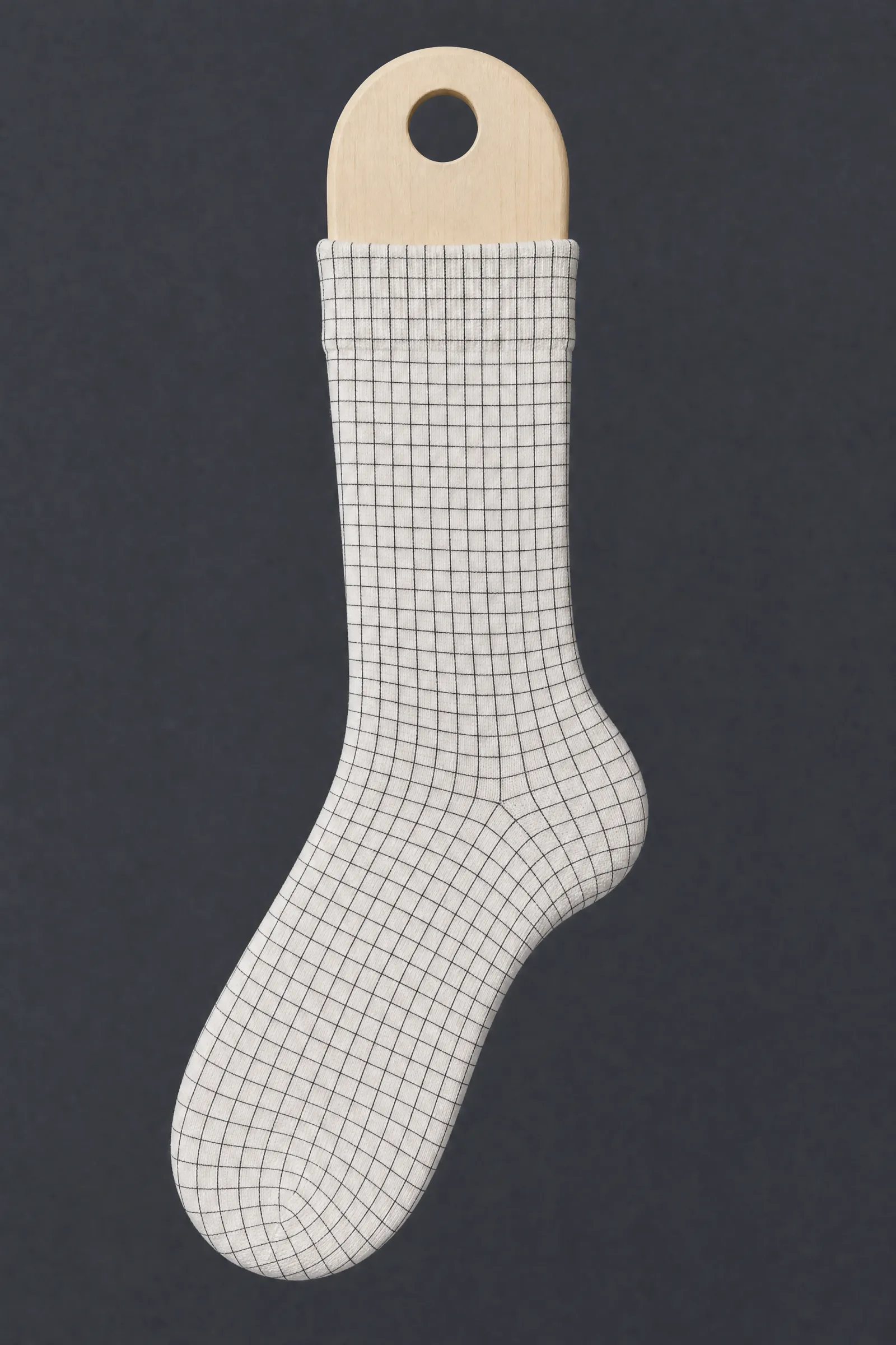 The Grid 04 pattern on a sock stretched over a sock form, showing how the drawing curves and compresses