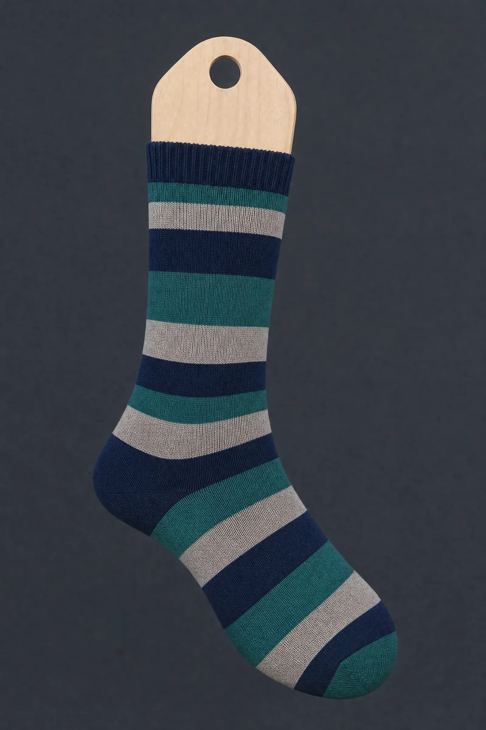 The Band Uneven pattern on a sock stretched over a sock form, showing how the drawing curves and compresses