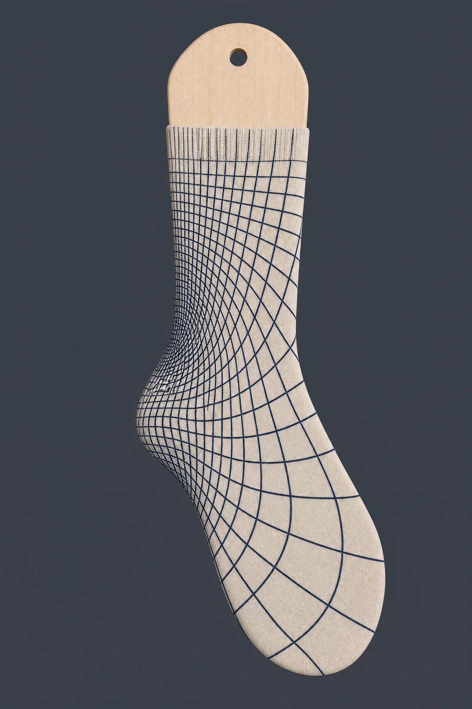 The Grid Fade pattern on a sock stretched over a sock form, showing how the drawing curves and compresses