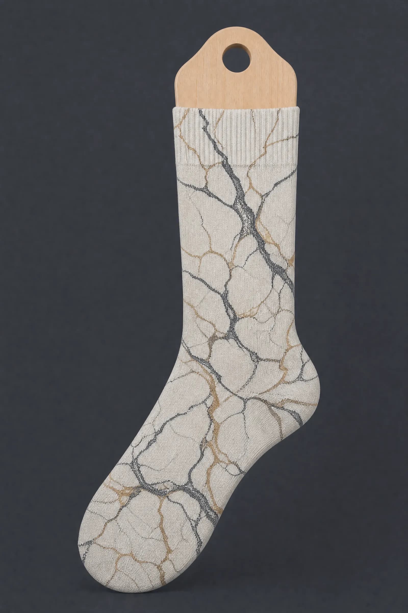 The Faux Marble pattern on a sock stretched over a sock form, showing how the drawing curves and compresses