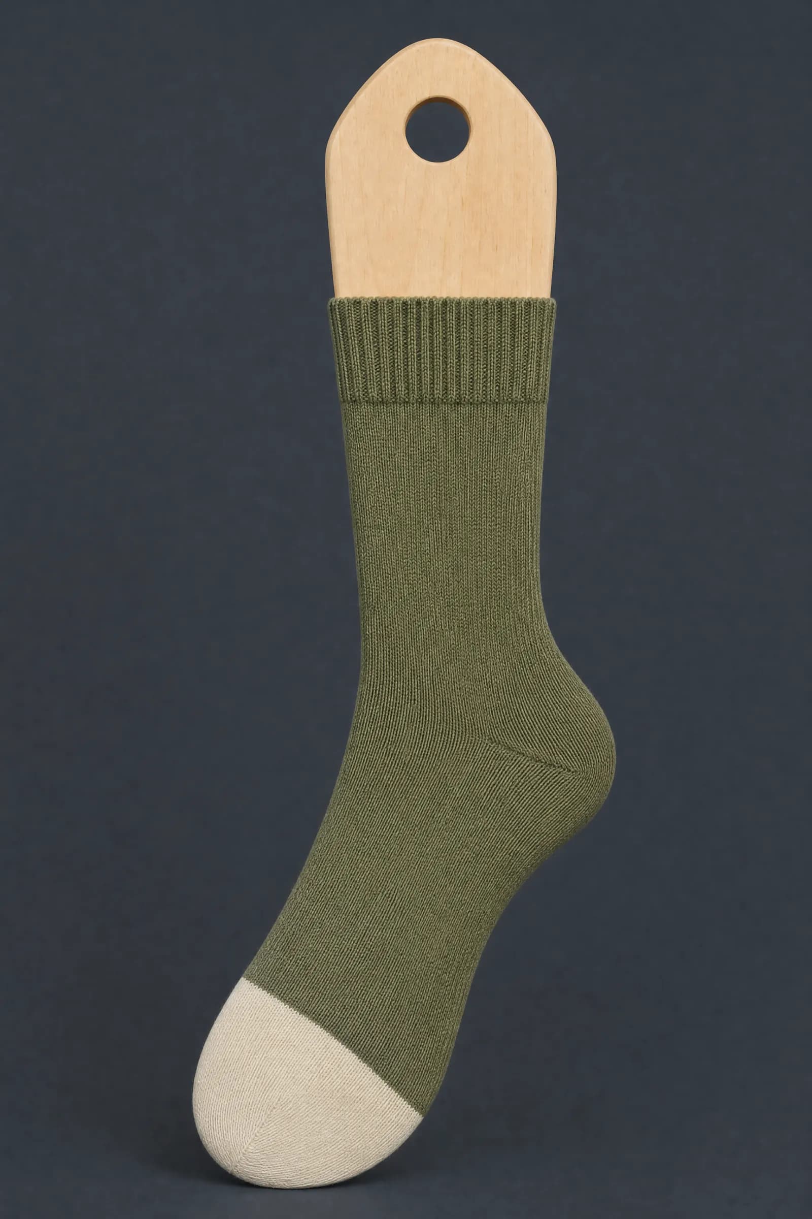 The Split Toe pattern on a sock stretched over a sock form, showing how the drawing curves and compresses