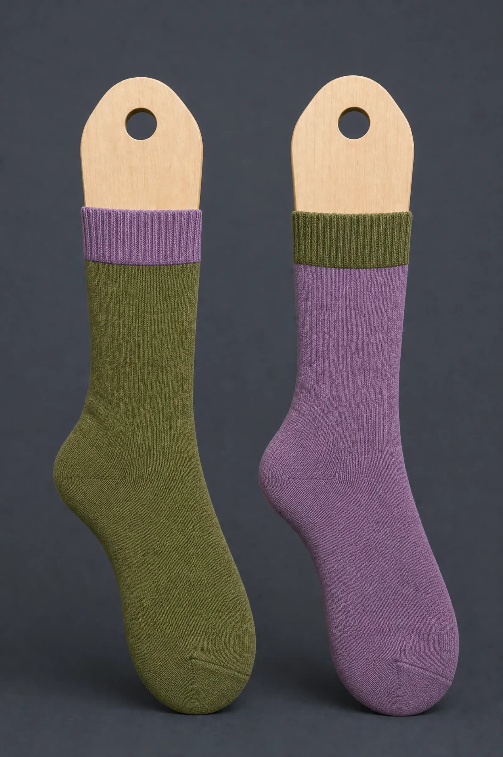 The Odd Pair pattern on a sock stretched over a sock form, showing how the drawing curves and compresses