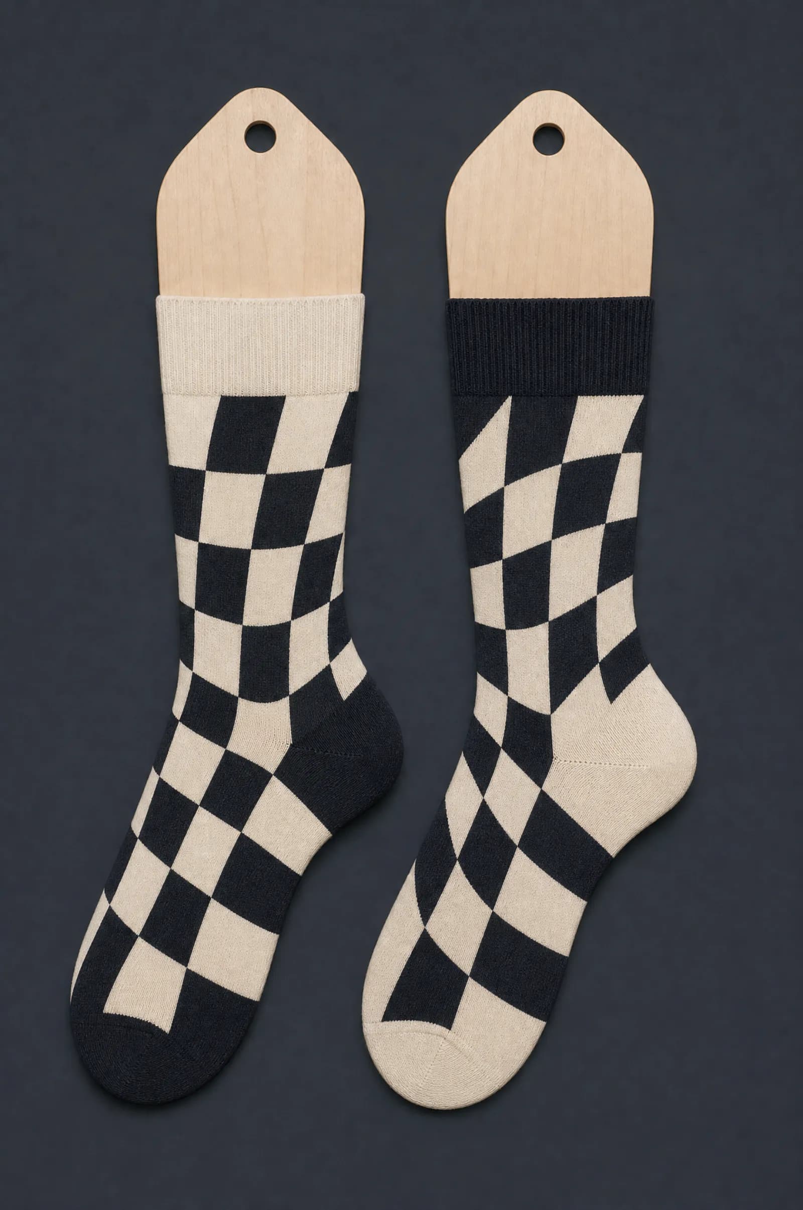The Inverse Pair pattern on a sock stretched over a sock form, showing how the drawing curves and compresses