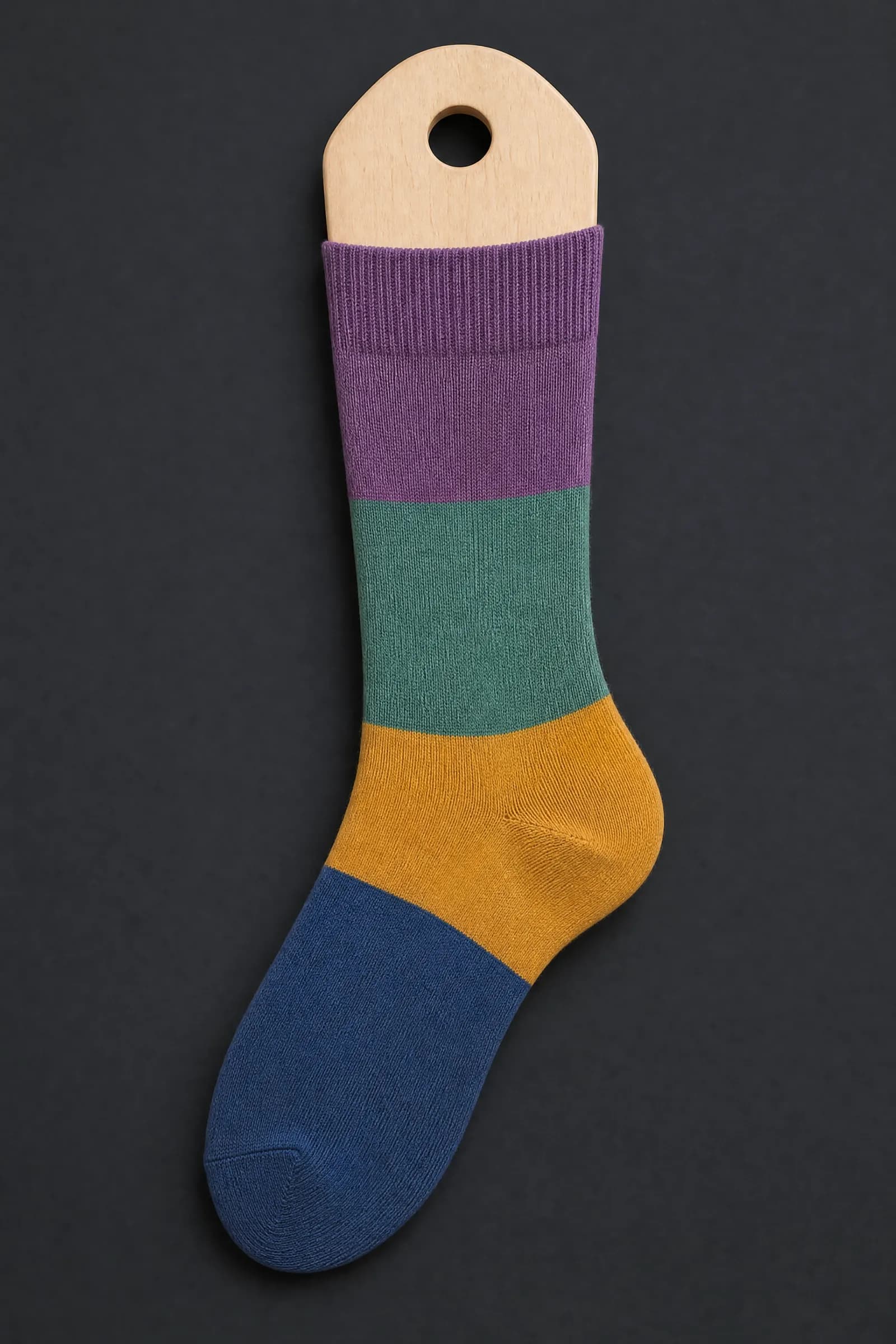 The Two-Tone Premium pattern on a sock stretched over a sock form, showing how the drawing curves and compresses