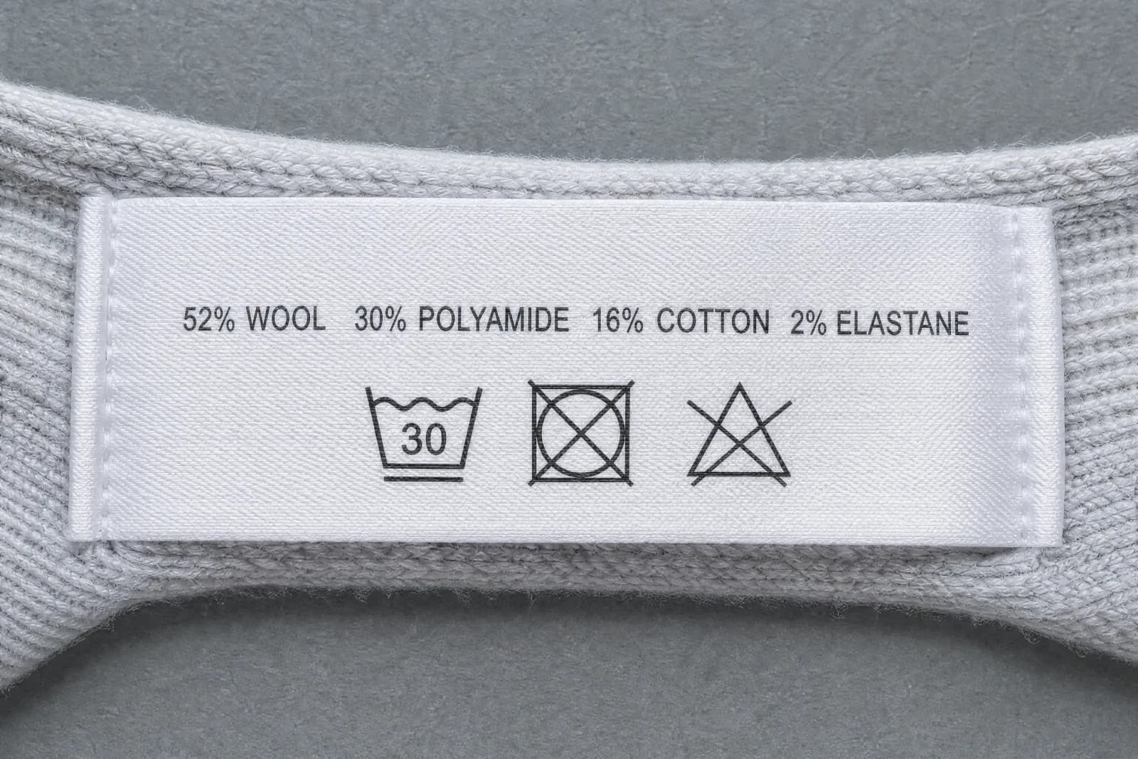 The sewn-in care label for Nature Premium, showing the fibre composition and wash symbols